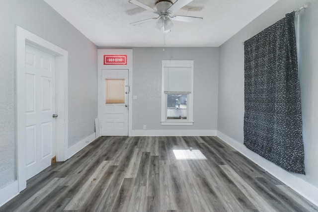 unfurnished room with dark hardwood / wood-style floors, ceiling fan, and a textured ceiling