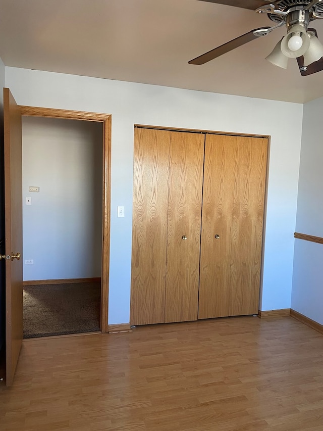 unfurnished bedroom with light wood-type flooring, a closet, and ceiling fan