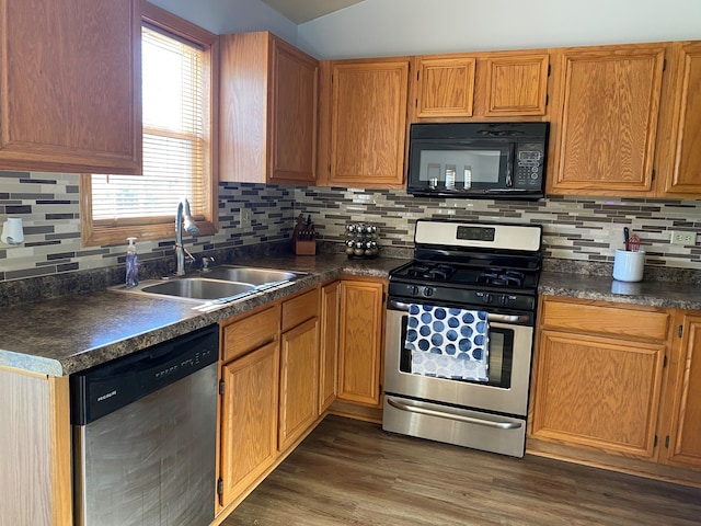 kitchen with decorative backsplash, sink, stainless steel appliances, and dark hardwood / wood-style floors