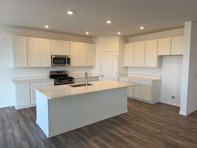 kitchen with a kitchen island with sink, sink, white cabinetry, and stainless steel appliances