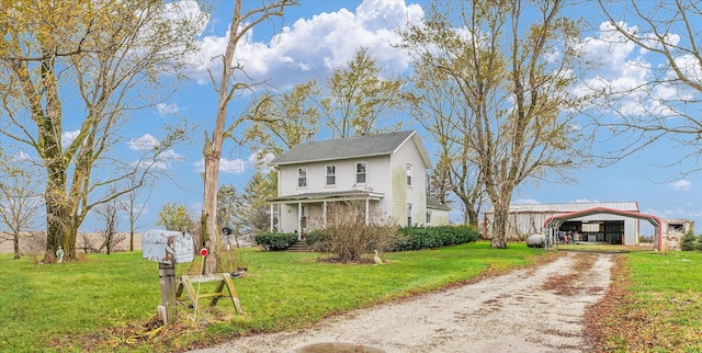 view of front of home featuring a front lawn and a carport