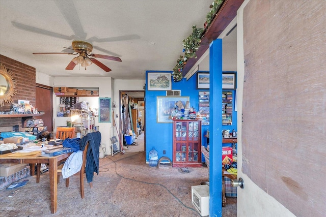 dining space with ceiling fan and a textured ceiling