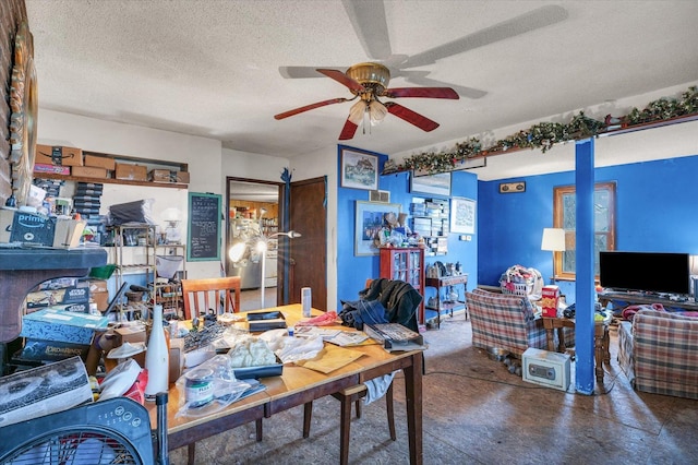 home office featuring concrete flooring, a textured ceiling, and ceiling fan