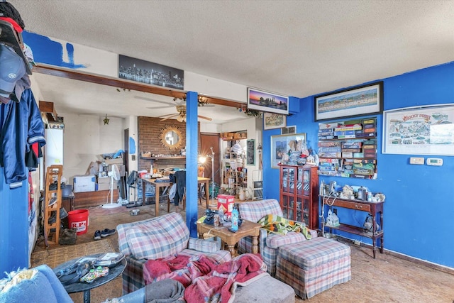 interior space featuring ceiling fan, carpet floors, and a textured ceiling