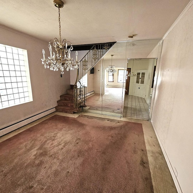 interior space featuring carpet flooring, ornamental molding, baseboard heating, a textured ceiling, and a notable chandelier