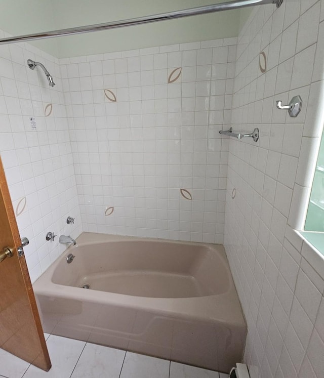 bathroom featuring tiled shower / bath combo and tile patterned floors