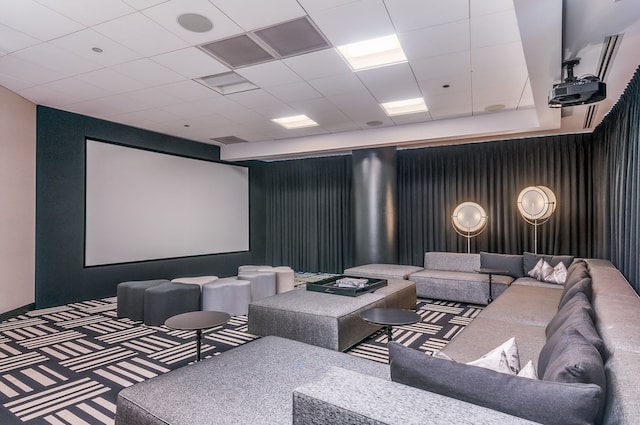 home theater room with a drop ceiling and carpet floors