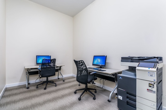 carpeted office featuring lofted ceiling