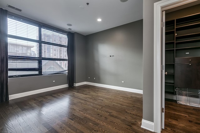 unfurnished room with dark hardwood / wood-style flooring