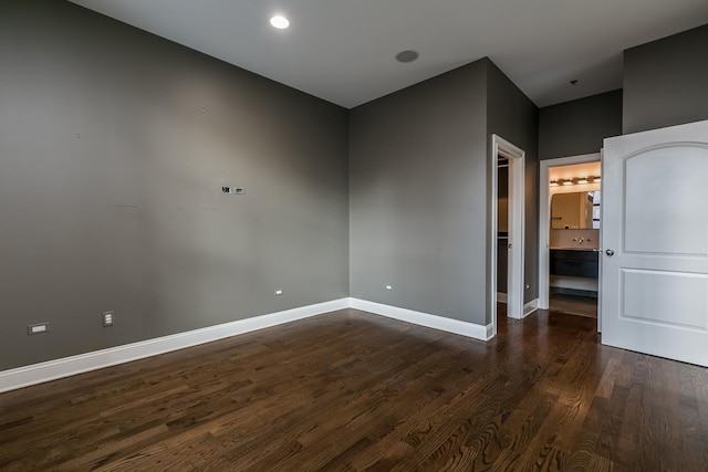 spare room featuring dark hardwood / wood-style flooring