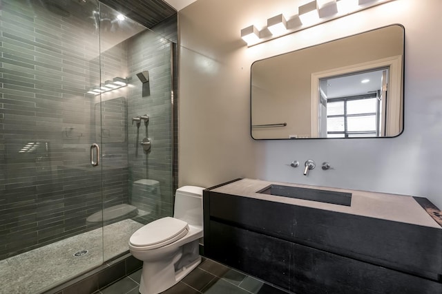 bathroom featuring tile patterned floors, vanity, an enclosed shower, and toilet