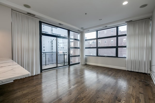 spare room with dark hardwood / wood-style floors