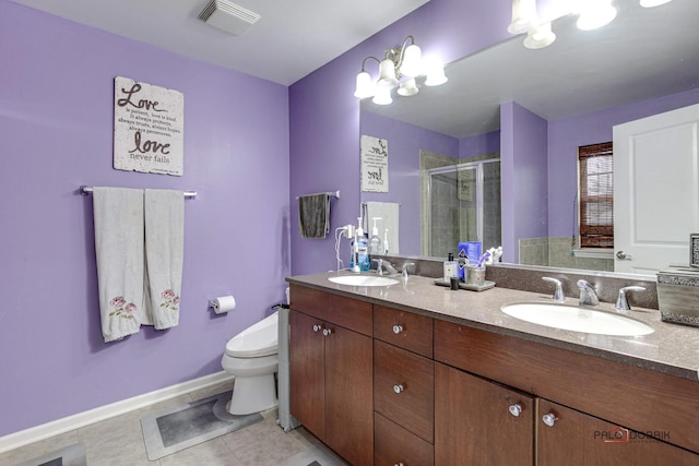 bathroom featuring vanity, an inviting chandelier, tile patterned floors, toilet, and a shower with shower door