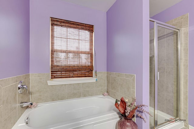 bathroom with separate shower and tub