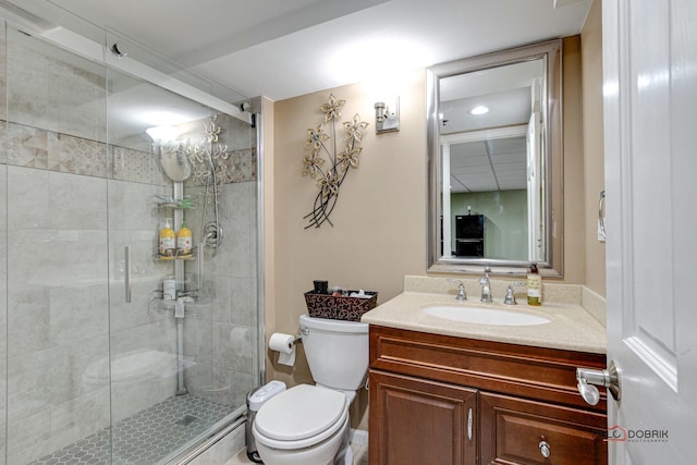 bathroom featuring vanity, an enclosed shower, and toilet