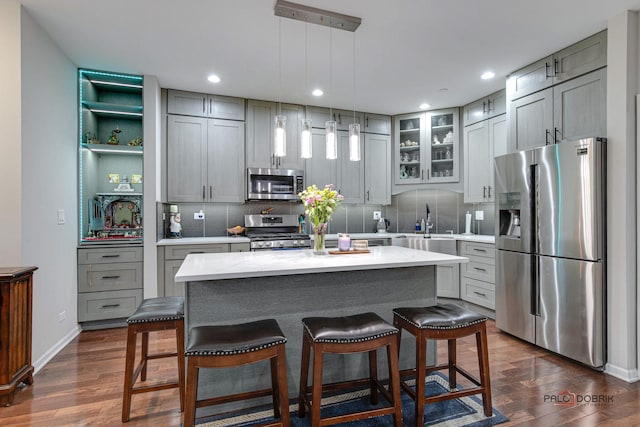 kitchen featuring gray cabinetry, a center island, and stainless steel appliances