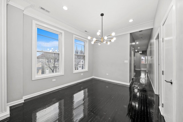 unfurnished dining area featuring dark hardwood / wood-style floors, an inviting chandelier, and ornamental molding