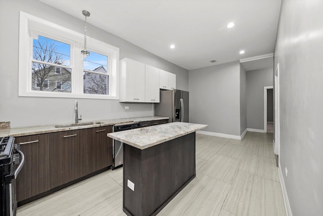 kitchen with sink, stainless steel appliances, a kitchen island, dark brown cabinets, and white cabinets