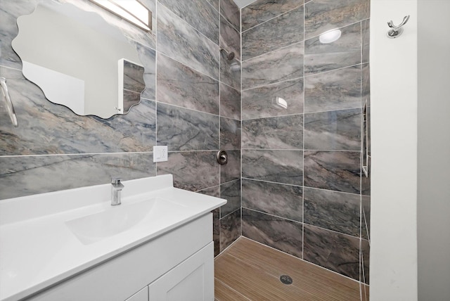 bathroom featuring vanity and a tile shower