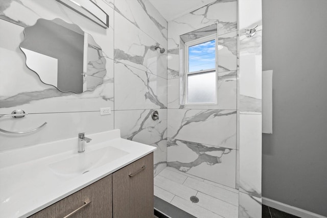 bathroom featuring a tile shower and vanity