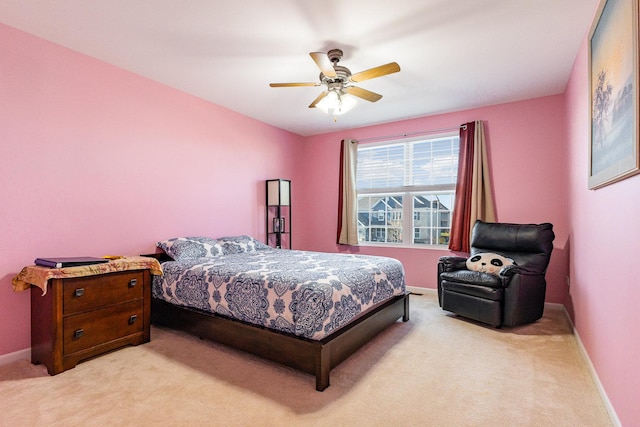 bedroom with light colored carpet, baseboards, and ceiling fan
