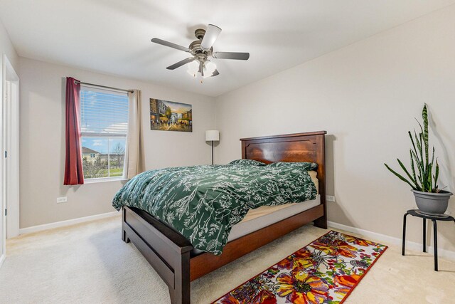 bedroom featuring baseboards, a ceiling fan, and carpet