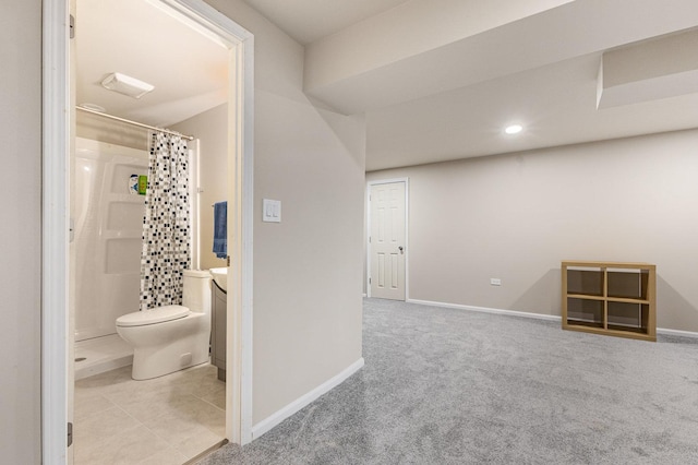 interior space with baseboards, toilet, recessed lighting, vanity, and a stall shower