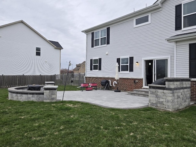 rear view of house featuring a patio, a yard, entry steps, and fence