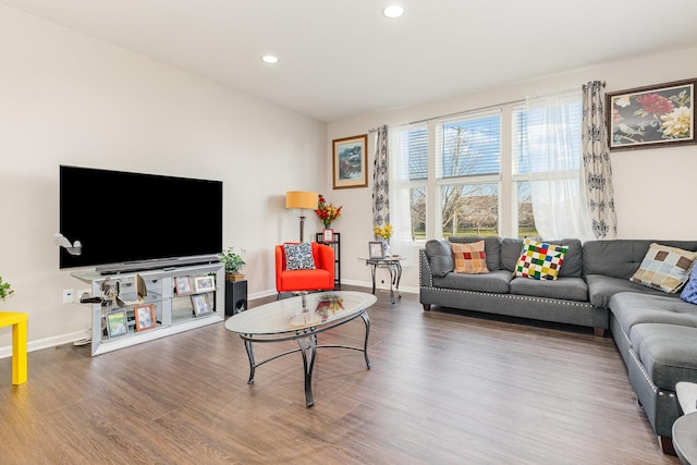 living area with wood finished floors, baseboards, and recessed lighting