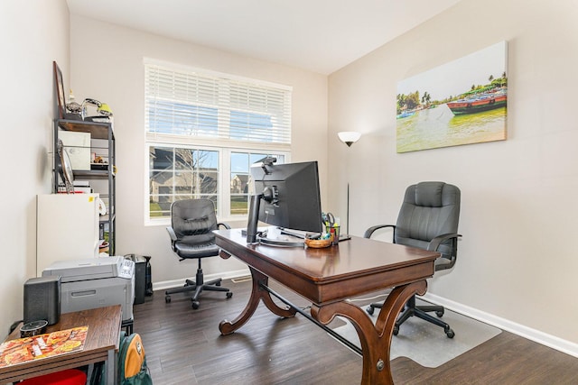 office with dark wood-style flooring and baseboards