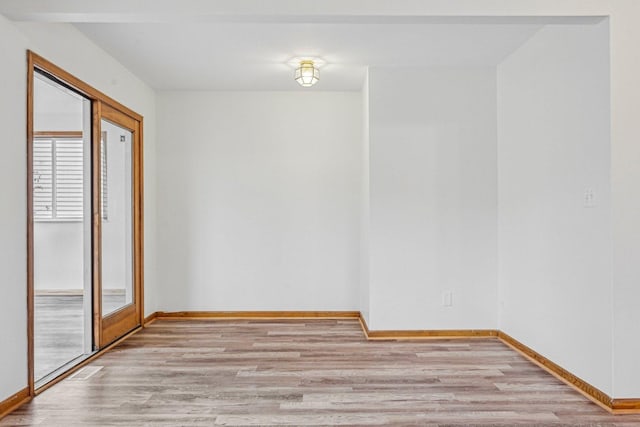 unfurnished room with light wood-type flooring