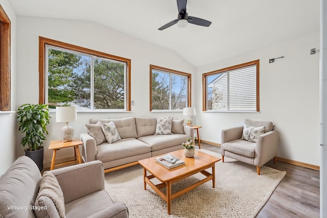 living room with light hardwood / wood-style floors, ceiling fan, and lofted ceiling