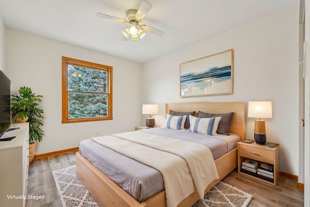 bedroom featuring light wood-type flooring and ceiling fan