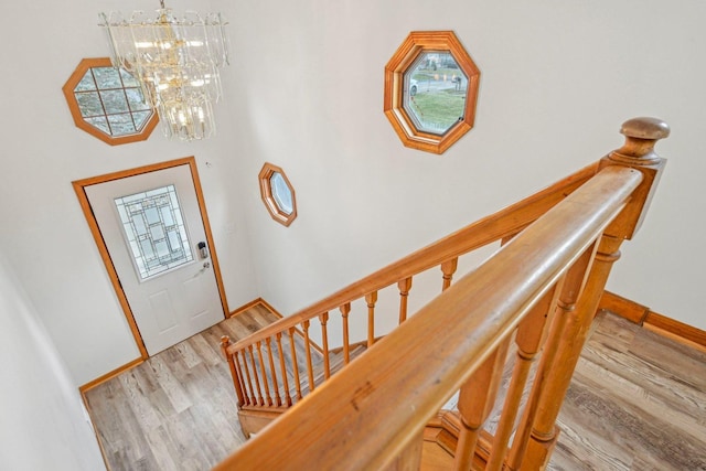 foyer with light hardwood / wood-style floors and an inviting chandelier