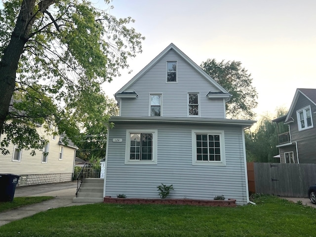 rear view of property with a yard