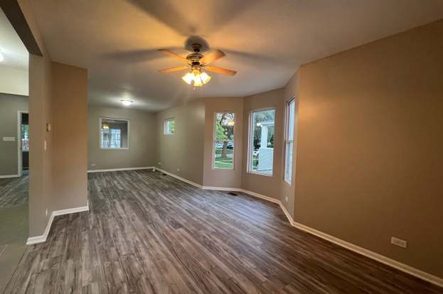 unfurnished room with ceiling fan and dark wood-type flooring