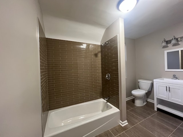 full bathroom with vanity, toilet, and tiled shower / bath