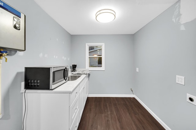 laundry area featuring dark hardwood / wood-style flooring