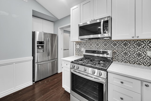 kitchen with backsplash, white cabinetry, dark wood-type flooring, and appliances with stainless steel finishes