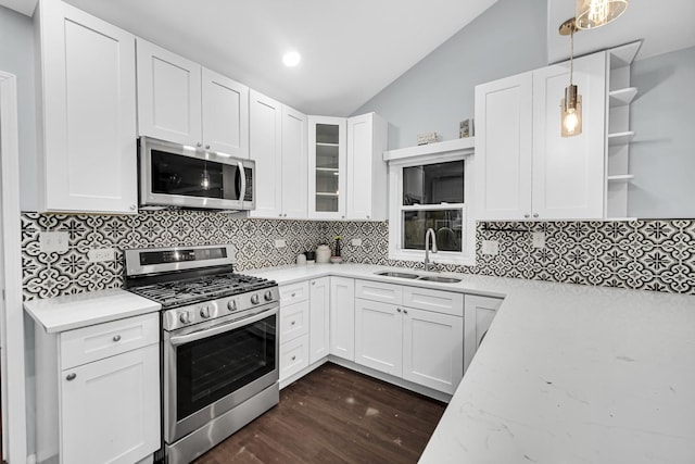 kitchen with pendant lighting, white cabinetry, sink, and appliances with stainless steel finishes