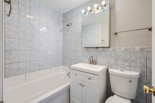 full bathroom with vanity, toilet, tile walls, and  shower combination