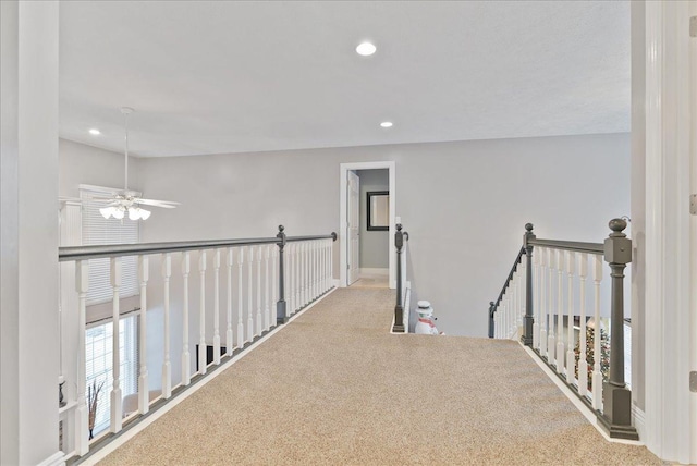 hallway featuring light colored carpet