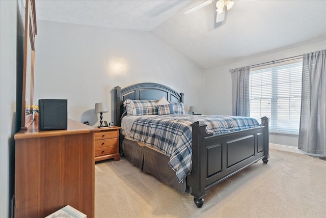 carpeted bedroom with ceiling fan and vaulted ceiling