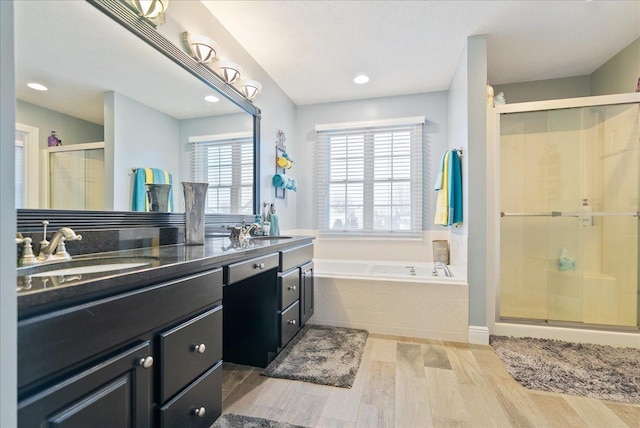 bathroom featuring hardwood / wood-style floors, vanity, and independent shower and bath