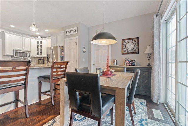 dining area with dark hardwood / wood-style floors