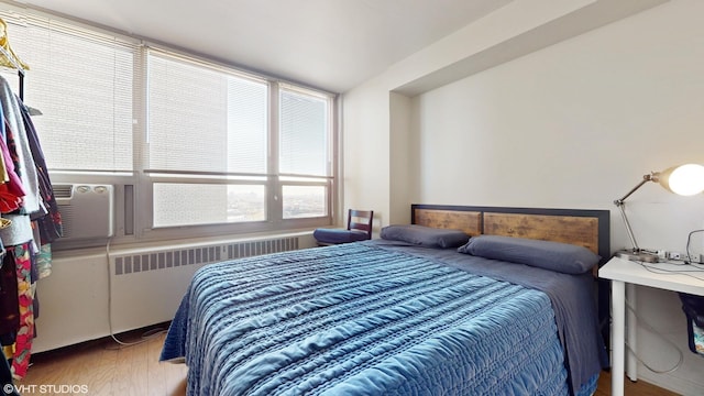 bedroom featuring wood-type flooring and radiator