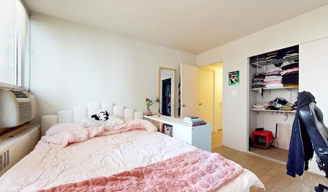 bedroom with light wood-type flooring and a closet