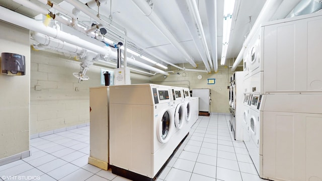 clothes washing area with washer and clothes dryer, light tile patterned floors, and stacked washer / dryer