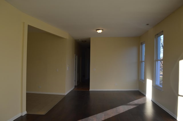 unfurnished room featuring dark wood-type flooring