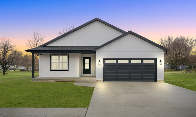 modern inspired farmhouse with a garage and a lawn